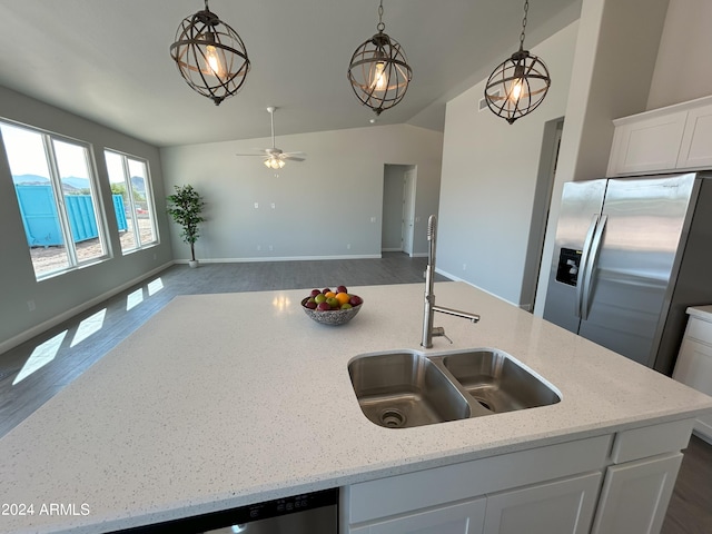 kitchen featuring light stone counters, sink, white cabinetry, and stainless steel refrigerator with ice dispenser