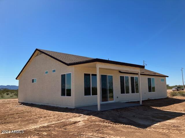 back of property with a patio