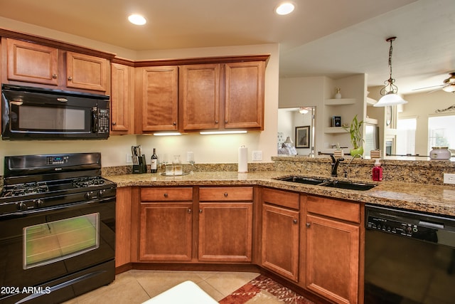 kitchen featuring black appliances, sink, hanging light fixtures, ceiling fan, and light tile patterned floors