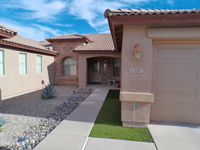 view of exterior entry featuring a garage