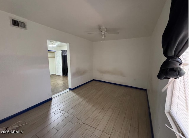 3112 W Taylor St, Phoenix, AZ 85009 - spare room featuring baseboards, ceiling fan, wood finished floors, and visible vents