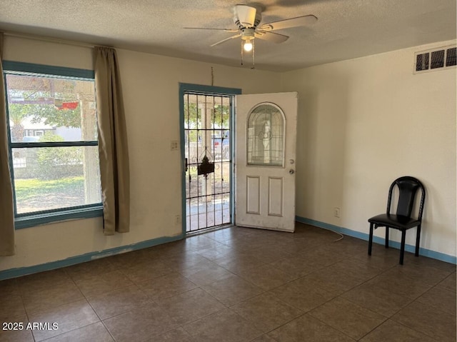 3112 W Taylor St, Phoenix, AZ 85009 - foyer entrance with visible vents, a ceiling fan, a textured ceiling, and baseboards