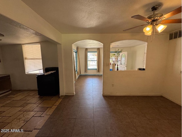 3112 W Taylor St, Phoenix, AZ 85009 - spare room featuring arched walkways, a textured ceiling, visible vents, and ceiling fan