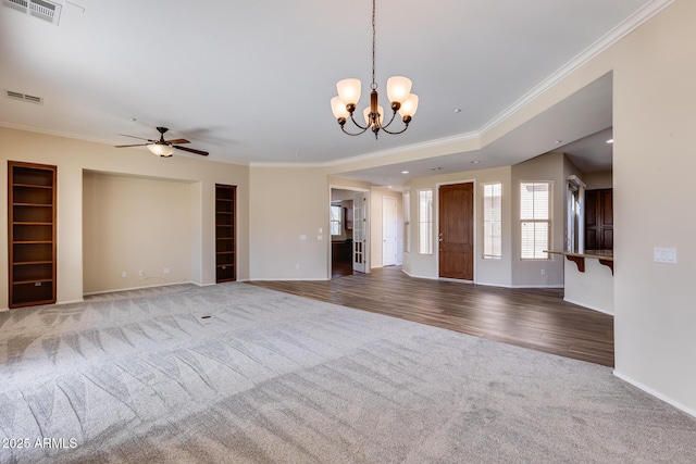 unfurnished living room featuring crown molding, carpet, and ceiling fan with notable chandelier