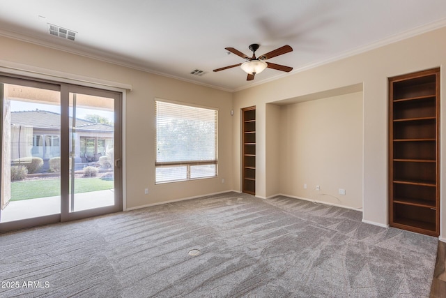 spare room with crown molding, carpet flooring, built in features, and ceiling fan