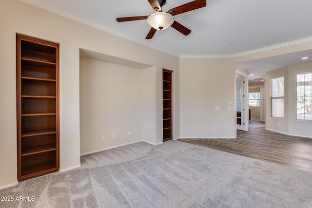 unfurnished living room featuring crown molding, ceiling fan, and carpet flooring