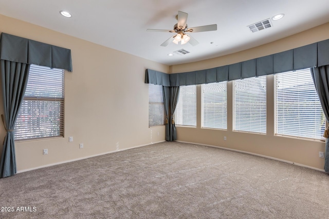 spare room with light colored carpet and ceiling fan