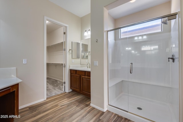 bathroom with vanity, hardwood / wood-style flooring, and walk in shower