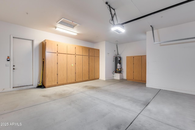 garage featuring a garage door opener and water heater