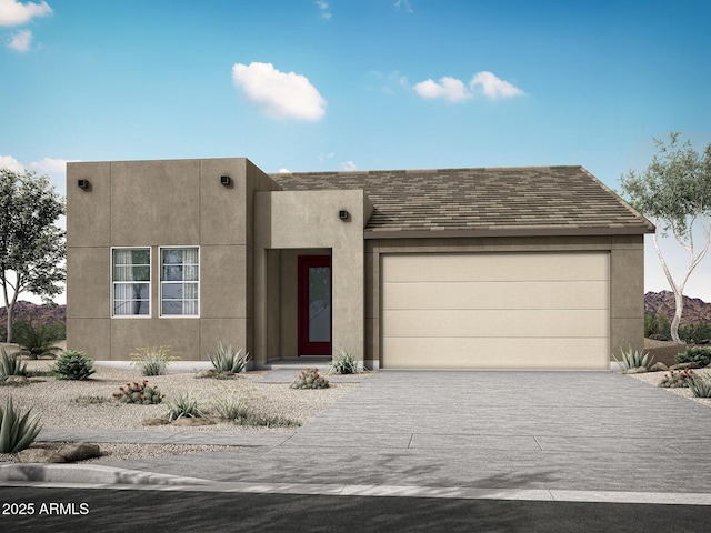 pueblo-style home featuring a garage, concrete driveway, and stucco siding