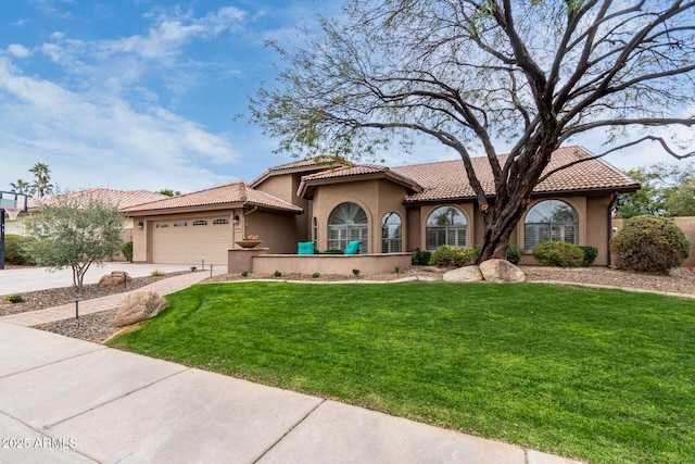 mediterranean / spanish-style house featuring an attached garage, a tile roof, a front yard, stucco siding, and driveway