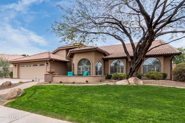 mediterranean / spanish home featuring stucco siding, driveway, a front lawn, and a garage