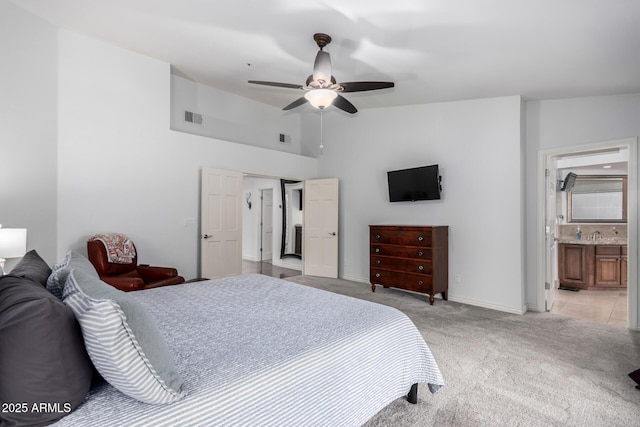 bedroom with baseboards, visible vents, light carpet, and lofted ceiling