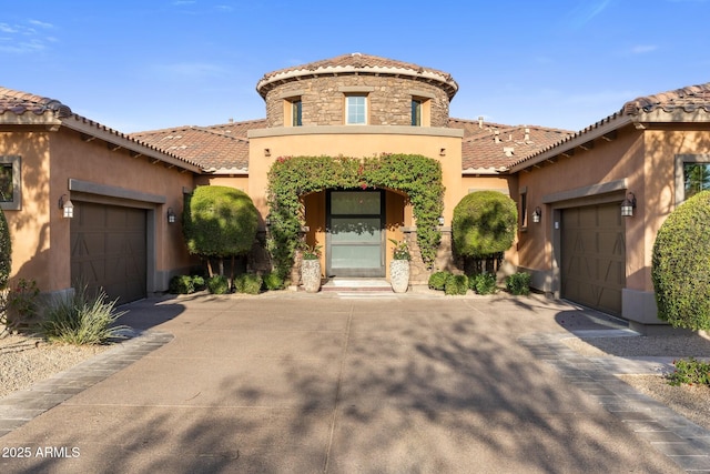 18127 N 98th Way, Scottsdale, AZ 85255 - mediterranean / spanish-style house with an attached garage, stucco siding, and a tiled roof