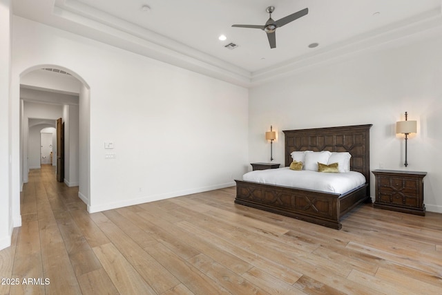 18127 N 98th Way, Scottsdale, AZ 85255 - bedroom featuring arched walkways, light wood-style floors, baseboards, a ceiling fan, and recessed lighting