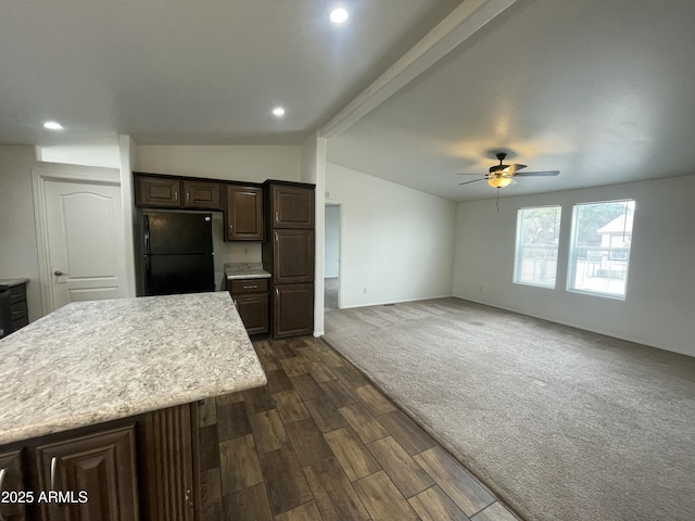 kitchen with lofted ceiling, freestanding refrigerator, dark brown cabinetry, ceiling fan, and light countertops