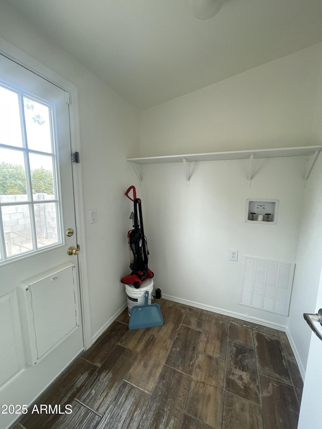 clothes washing area with wood finished floors, laundry area, visible vents, baseboards, and hookup for a washing machine