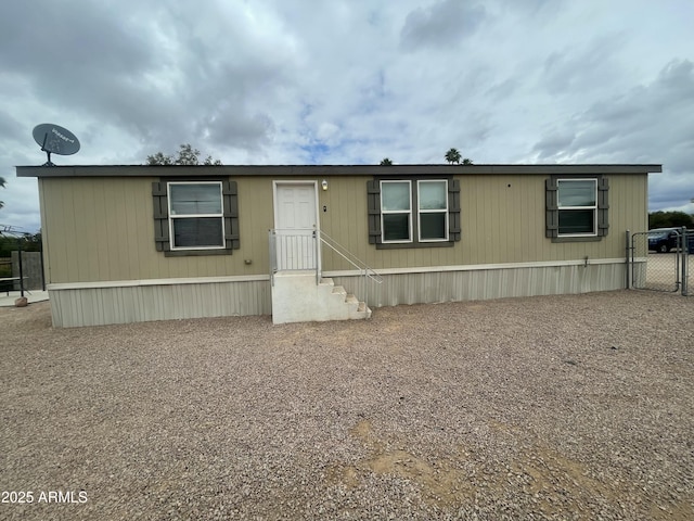 manufactured / mobile home with a gate and fence