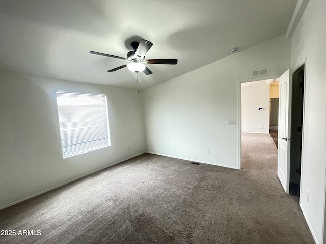 carpeted spare room featuring baseboards, ceiling fan, and visible vents