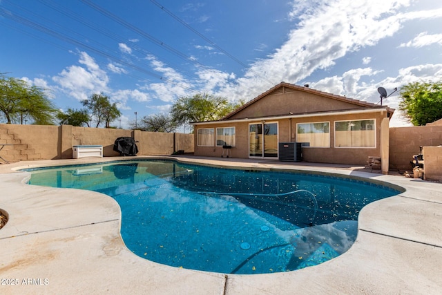 view of pool featuring a fenced in pool, a patio area, central air condition unit, and a fenced backyard