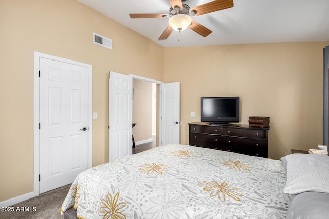 carpeted bedroom featuring visible vents, baseboards, a ceiling fan, and lofted ceiling