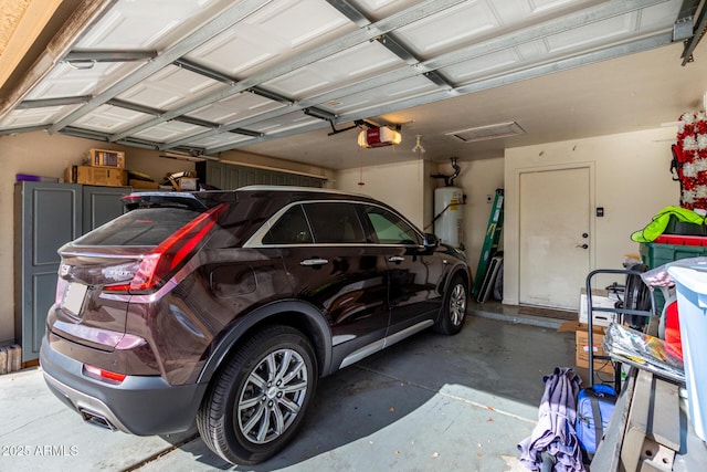 garage with water heater and a garage door opener