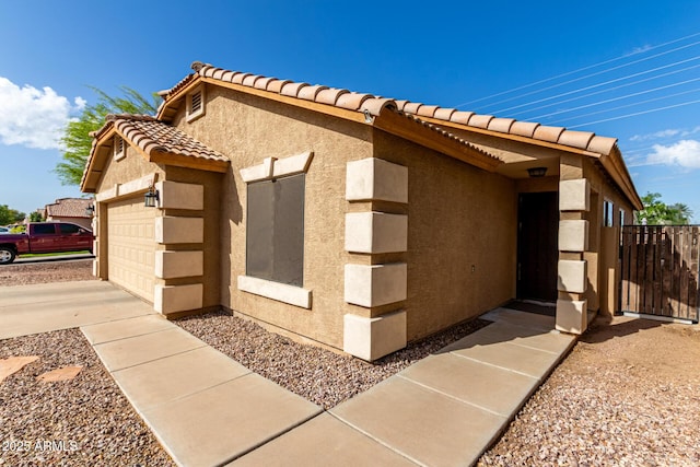 view of property exterior featuring stucco siding and a tile roof