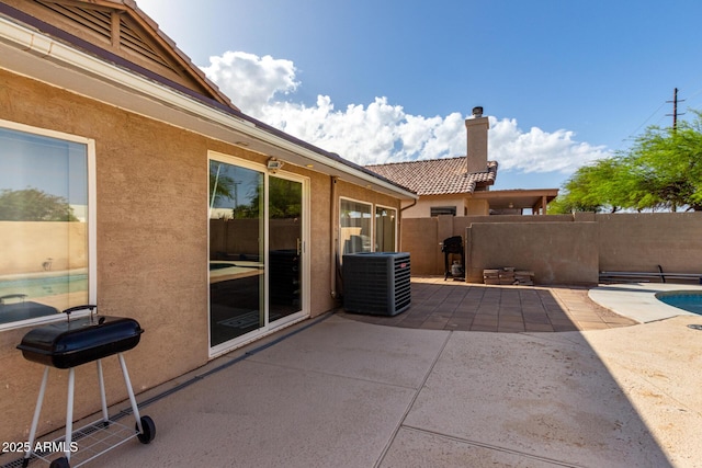view of patio / terrace with fence and central air condition unit
