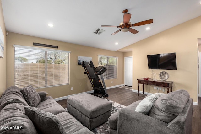 living area with visible vents, baseboards, a ceiling fan, dark wood finished floors, and vaulted ceiling