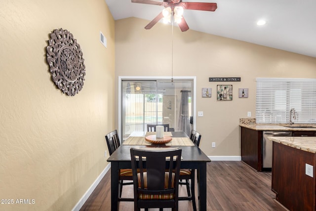 dining room with a ceiling fan, visible vents, vaulted ceiling, dark wood-style flooring, and baseboards