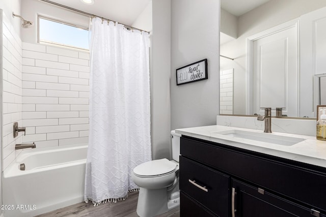 full bathroom featuring toilet, shower / tub combo, wood finished floors, and vanity