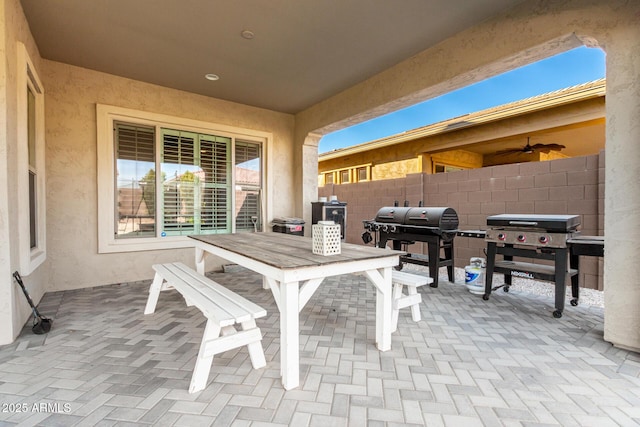 view of patio / terrace featuring a ceiling fan, outdoor dining area, fence, and area for grilling