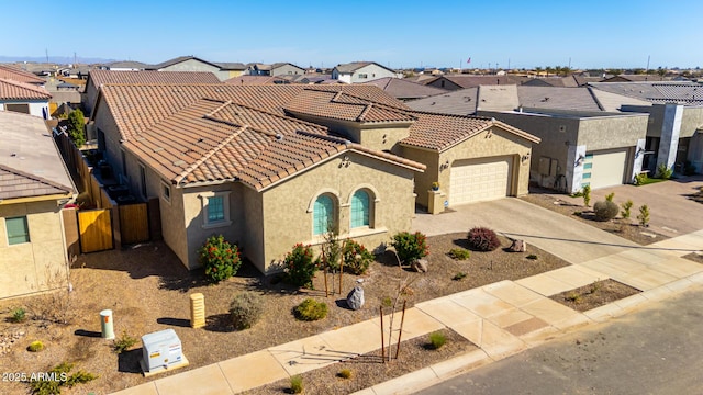 view of front facade with a tile roof, a residential view, and stucco siding