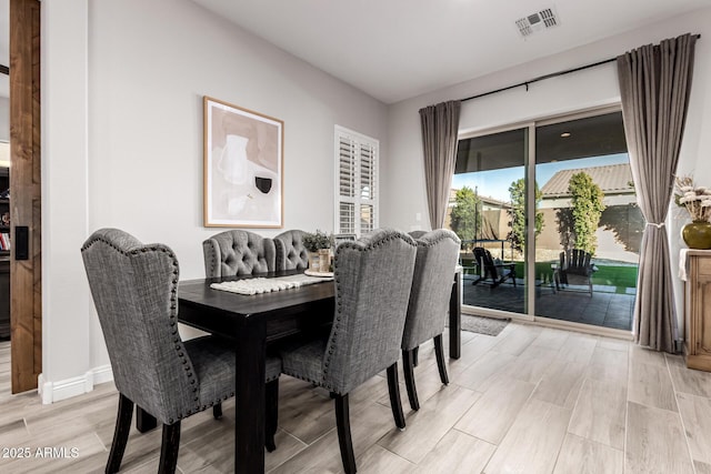 dining room with wood finish floors and visible vents