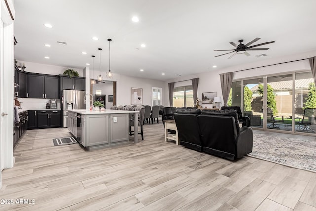 living area featuring recessed lighting, a healthy amount of sunlight, and visible vents