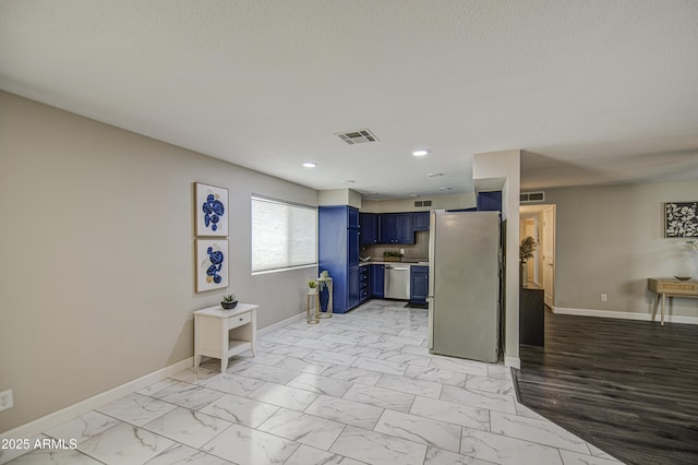 8523 W Whitton Ave, Phoenix, AZ 85037 - kitchen with blue cabinets, stainless steel appliances, baseboards, light marble finish flooring, and light countertops