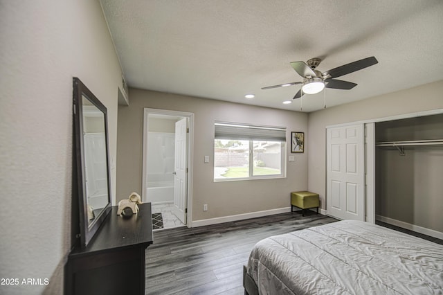 8523 W Whitton Ave, Phoenix, AZ 85037 - bedroom with wood finished floors, a closet, baseboards, a textured ceiling, and ensuite bath