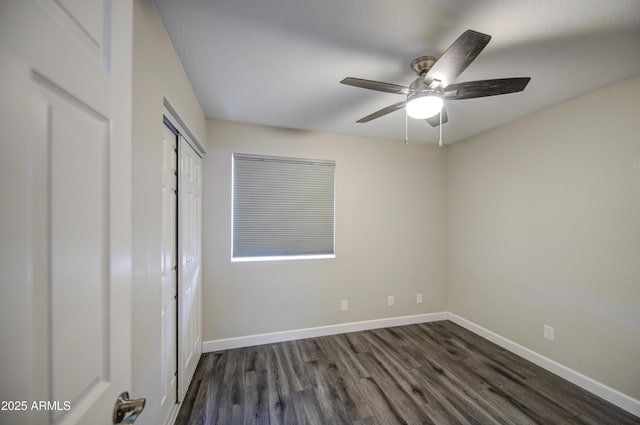 8523 W Whitton Ave, Phoenix, AZ 85037 - unfurnished bedroom featuring dark wood-type flooring, baseboards, a closet, and a ceiling fan