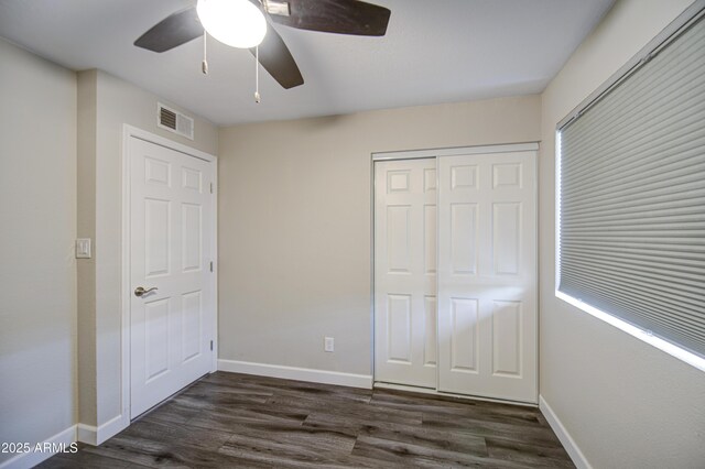 8523 W Whitton Ave, Phoenix, AZ 85037 - unfurnished bedroom featuring dark wood finished floors, a closet, and baseboards