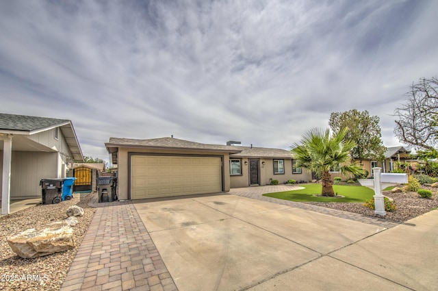 8523 W Whitton Ave, Phoenix, AZ 85037 - ranch-style house with concrete driveway, stucco siding, a garage, and a gate