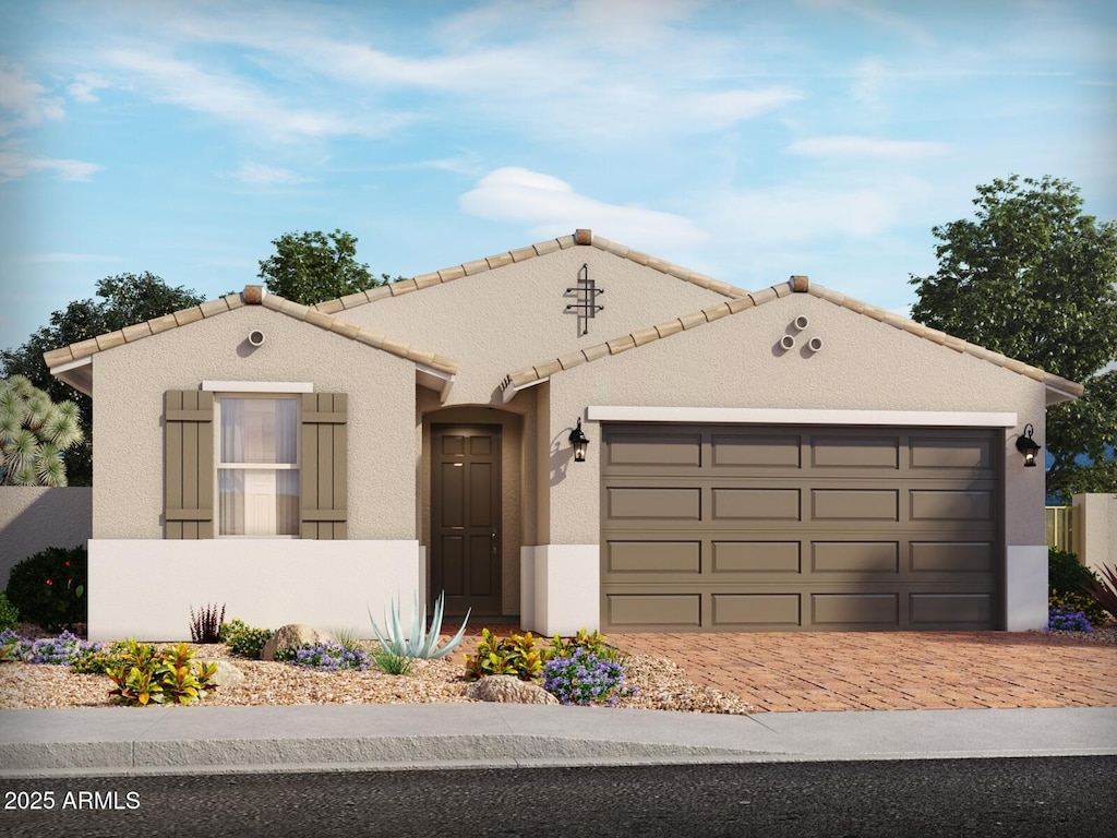 137 N 175th Ln, Goodyear, AZ 85338 - mediterranean / spanish-style house with an attached garage, decorative driveway, stucco siding, and a tile roof