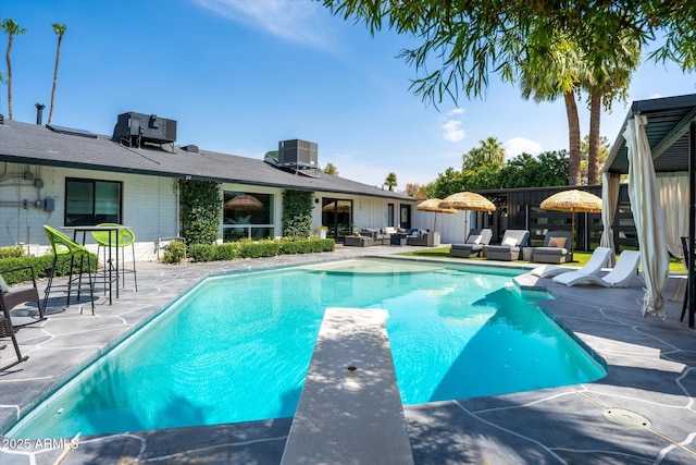 7508 N 13th Ave, Phoenix, AZ 85021 - swimming pool featuring an outdoor living space, a patio, a diving board, and cooling unit
