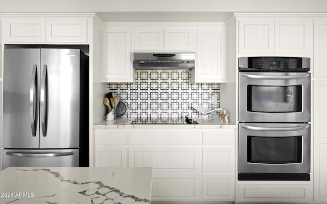 7508 N 13th Ave, Phoenix, AZ 85021 - kitchen featuring stainless steel appliances, exhaust hood, white cabinetry, and backsplash