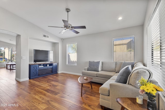 living room featuring lofted ceiling, dark wood finished floors, a ceiling fan, and baseboards