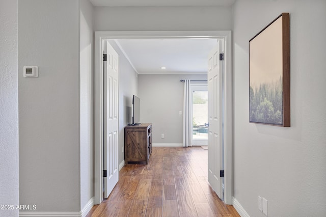 hallway with wood finished floors and baseboards