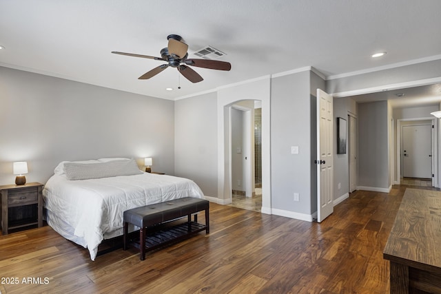 bedroom with arched walkways, wood finished floors, baseboards, ornamental molding, and recessed lighting