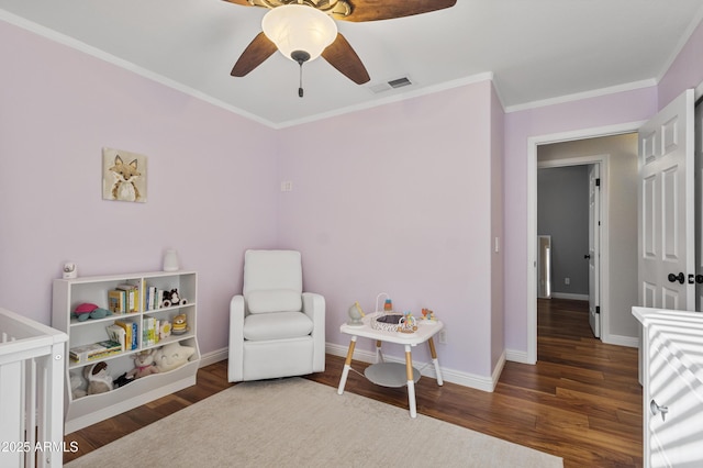 bedroom featuring crown molding, wood finished floors, baseboards, and ceiling fan
