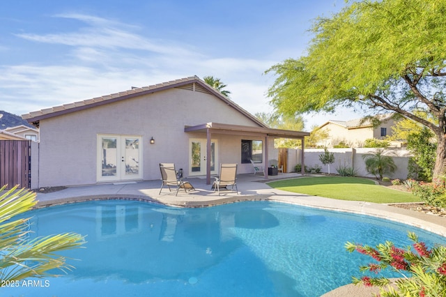 view of swimming pool featuring a fenced backyard, a patio area, and french doors