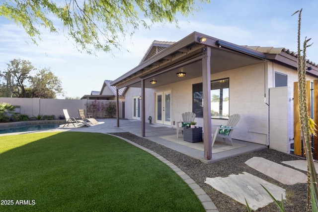 rear view of property featuring french doors and a patio