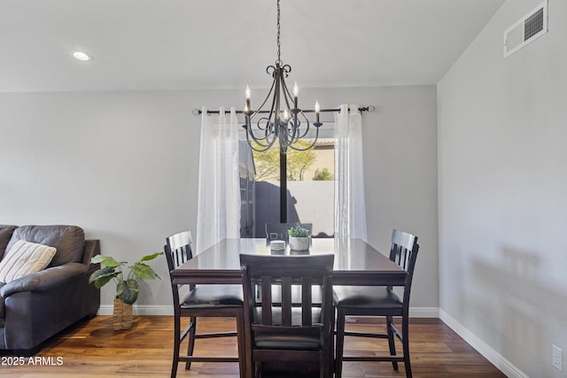 dining space featuring a chandelier, baseboards, wood finished floors, and recessed lighting